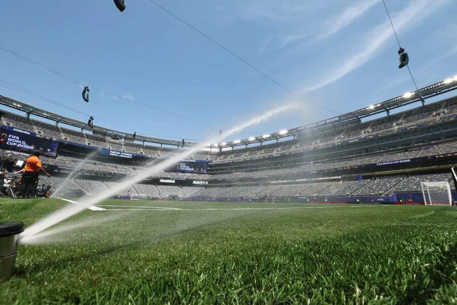 The pitch being watered by sprinklers at MetLife Stadium.