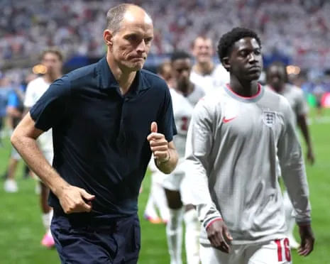 Thomas Tuchel and Kobbie Mainoo leave the field after England's defeat by Argentina in the World Cup semi-finals