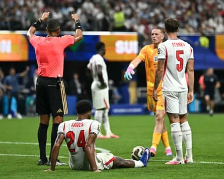 England’s Reece James awaits treatment after going down with cramp in the semi-final against Argentina.
