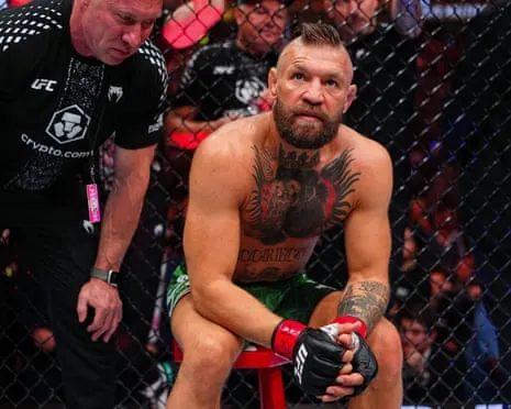 Conor McGregor stares ahead during an injury stoppage in his UFC return fight.