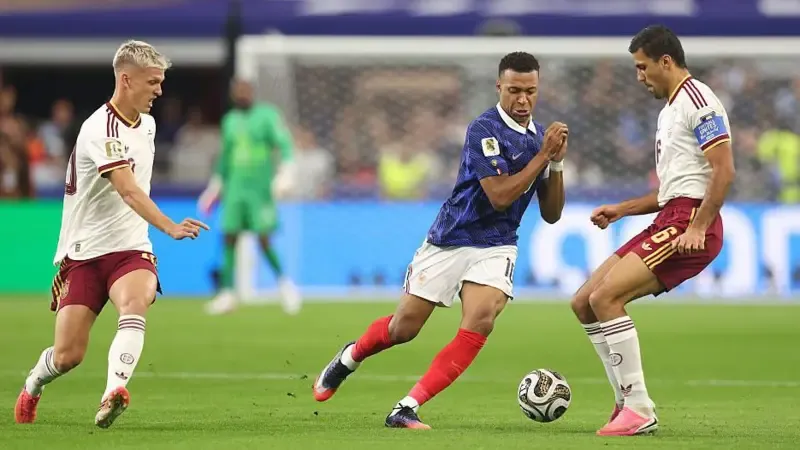 Rodri and Dani Olmo keep possession under pressure from Kylian Mbappe